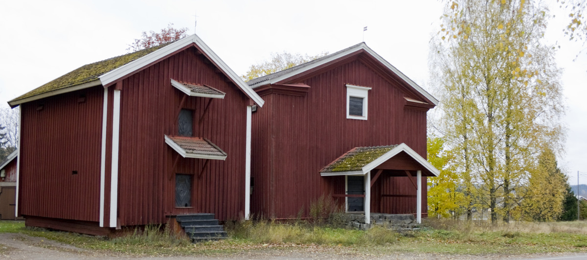 Två röda tvåvåningsmagasin som hör till Nummi hembygdsmuseum.